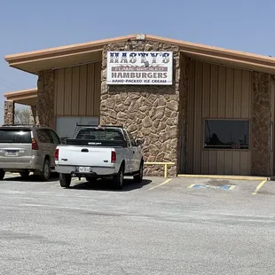 two trucks parked in front of a restaurant