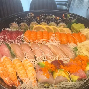 Sushi party tray. Tuna/ salmon/ yellowtail/ rainbow roll .