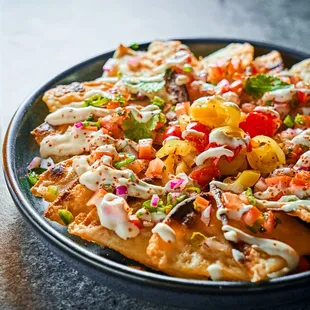 a plate of nachos and a glass of beer