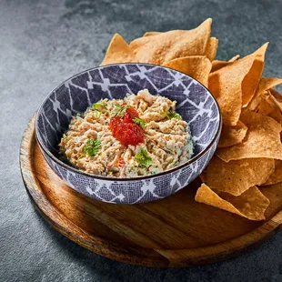 a bowl of tuna salad with tortilla chips