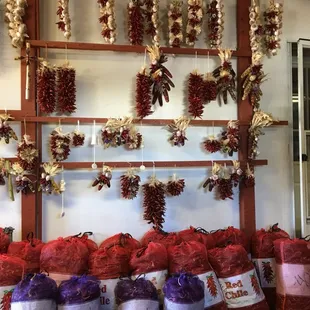 a variety of chilis hanging from the ceiling