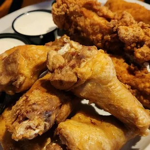 a plate of fried chicken wings and dipping sauce