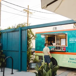 a man ordering food from a food truck