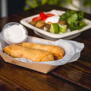 a basket of fish and chips and a salad