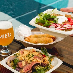 two plates of food and a glass of beer