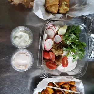 a meal in a plastic container with a variety of toppings