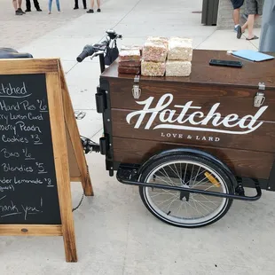 a bicycle with a cart of food on the back