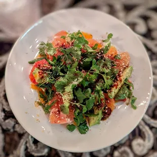 Citrus and avocado with almond salsa macha, sesame and sumac.