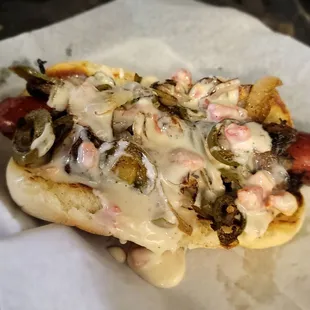 a hot dog covered in toppings