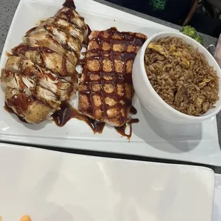 Teriyaki chicken and salmon with a side of fried rice