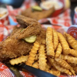 Half chicken with fries split on two baskets