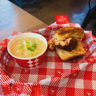 Hot chicken biscuit with pimento cheese served with bacon cheddar grits.