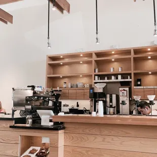 a coffee shop counter with a variety of coffees