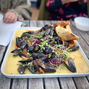 a plate of mussels and bread
