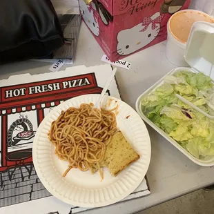 a plate of spaghetti and salad