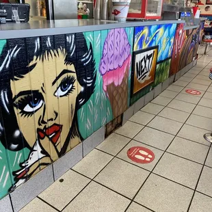 a woman's face painted on a wall