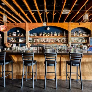 a row of bar stools at a bar