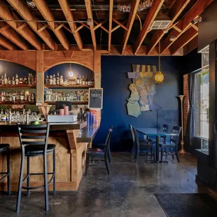 a bar with a lot of bottles on the shelves