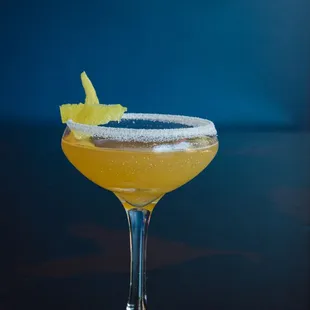 a close up of a drink in a coupe glass