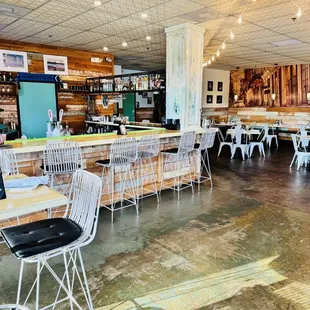 the inside of a restaurant with tables and chairs