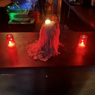a lit candle in the middle of the bar