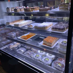 a display case with a variety of desserts