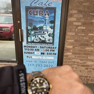 a man's hand holding a watch