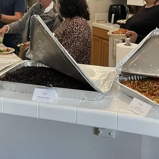 Trays with sofrito rico, black beans, corn saute.