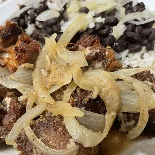 Fried Pork Chunks with black beans and rice.