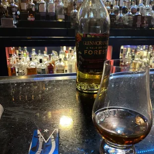 a bottle of rum and a glass of rum