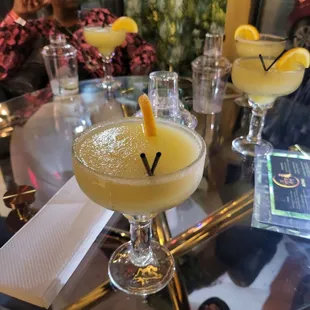 wo cocktails on a glass table