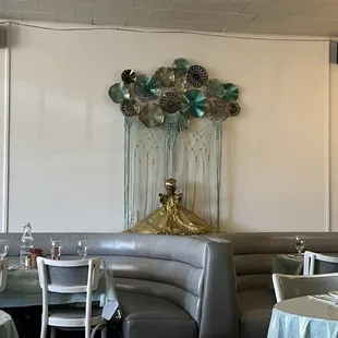 tables and booths with balloons hanging from the ceiling