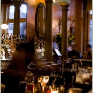 a man sitting at a bar in a restaurant