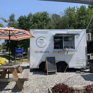 a white food truck parked in a parking lot