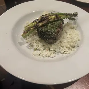 Salmon En Papillote salmon topped with Chimichurri  with asparagus and rice.