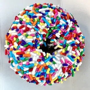 cake donut, white frosting, rainbow sprinkles