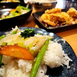 Pad pak and shrimp tempura in the background