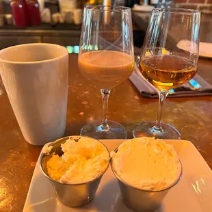 three glasses of wine and two bowls of ice cream