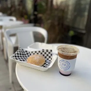 a cup of coffee and a donut on a table