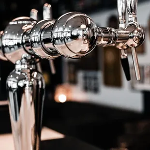 a row of beer taps