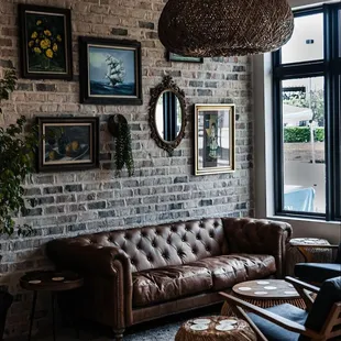 a living room with a brick wall