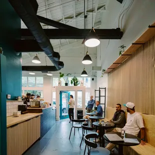 people sitting at tables in a cafe