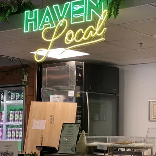 a neon sign above a counter