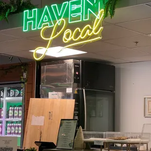 a neon sign above a counter