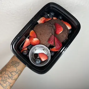 Dark chocolate chip protein pancakes with sugar free syrup, strawberries and blueberries