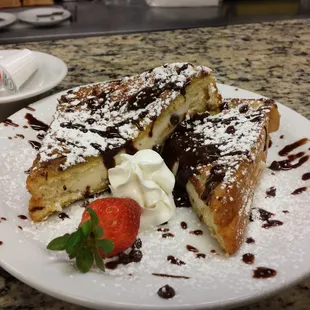 Cannoli Stuffed French Toast with a homemade chocolate drizzled over top !