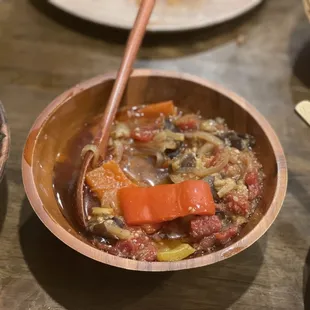 a bowl of stew and a bowl of vegetables