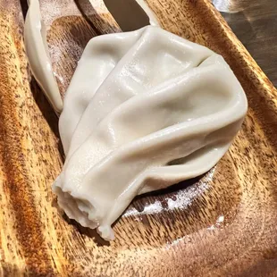 a plate of dumplings on a wooden table