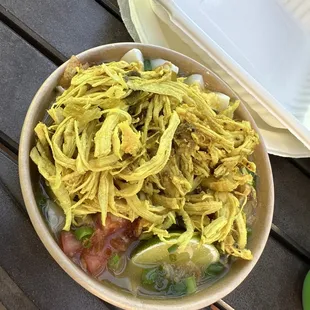 Soto ayam. Topped with chicken.