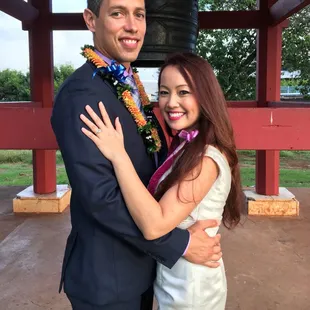 Happy couple just got married in front of the peace bell.